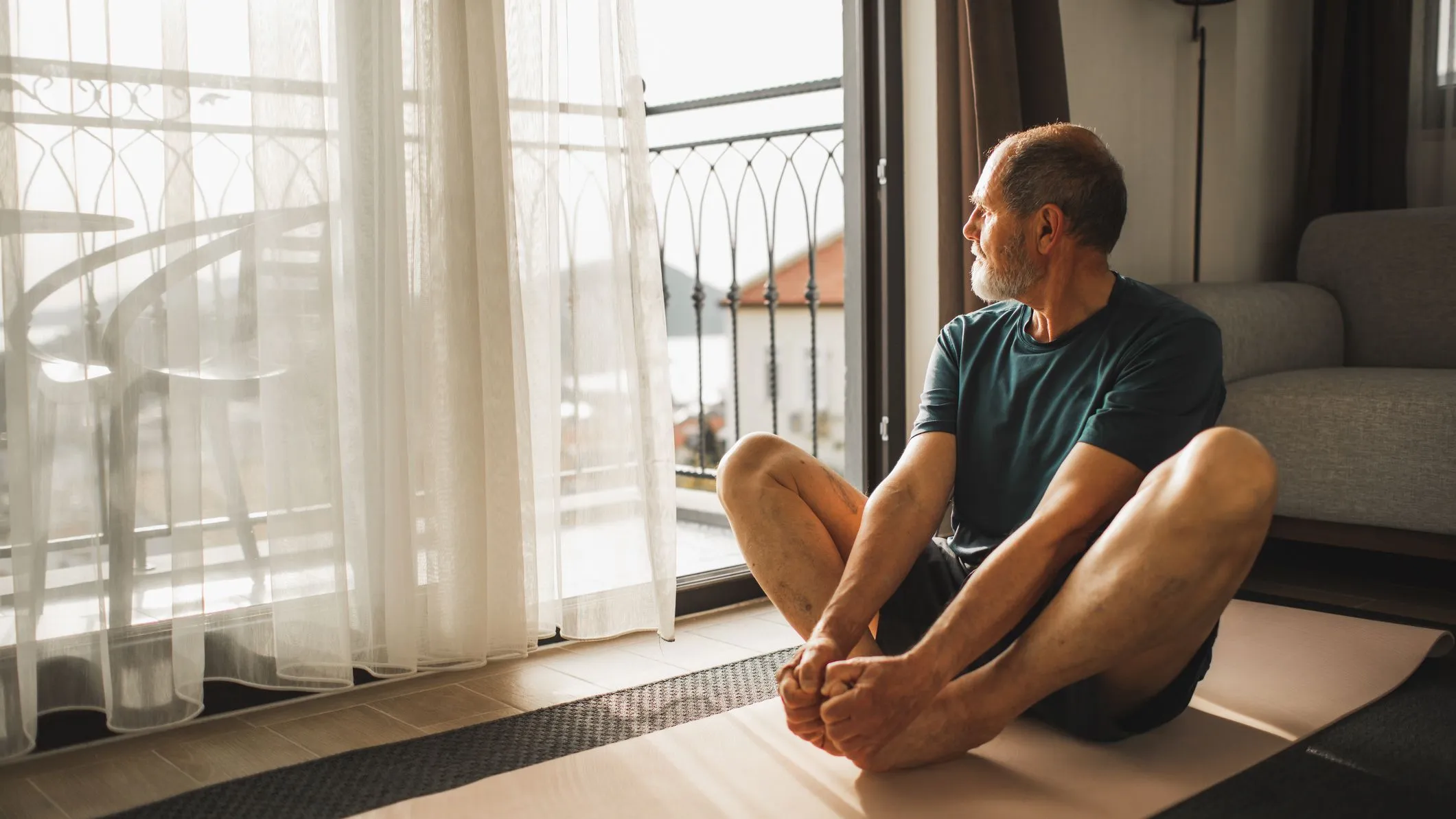 Person stretching in a bright room